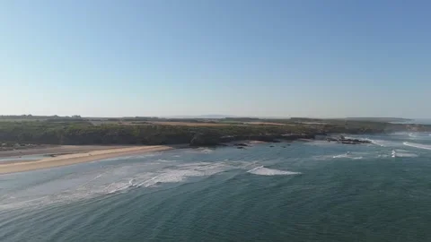 Aerial view of waves breaking along a wild beach and green coast, Portugal Stock Footage 346372983