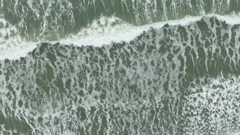 Aerial view of waves breaking onto a beach in Britain, 4K Stock Footage 143664160