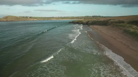 Aerial view of waves breaking on the beach in Cornwall, United Kingdom. Stock Footage 219546101