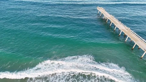 Aerial View of Waves Breaking Near Sand Bypass Jetty at Main Beach Stock Footage 341305779