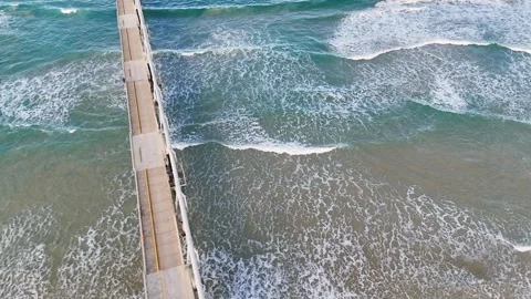 Aerial View of Waves Breaking Near Sand Bypass Jetty at Main Beach Stock Footage 341456650