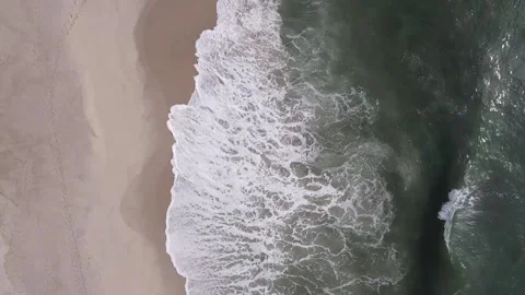 Aerial View of Waves breaking in the sand Stock Footage