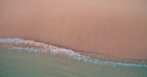Aerial view waves breaking on a sandy beach Stock Footage 90209843
