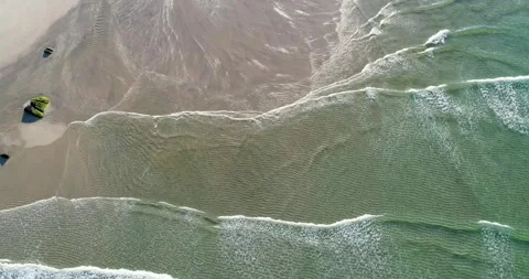 Aerial view of waves breaking on sandy beach. The Concept of Relaxation. Stock Footage 325907816