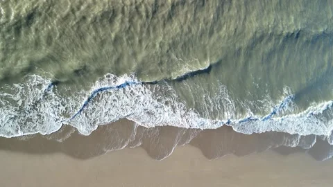 Aerial View of Waves Breaking on a Sandy Beach Along the North Sea Coast Video stock 344647815