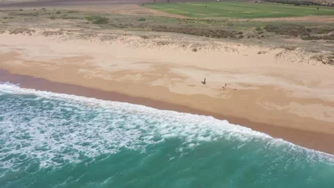 Aerial view of waves breaking on the shore of the sandy beach in south Spain. Stock Footage 143657296