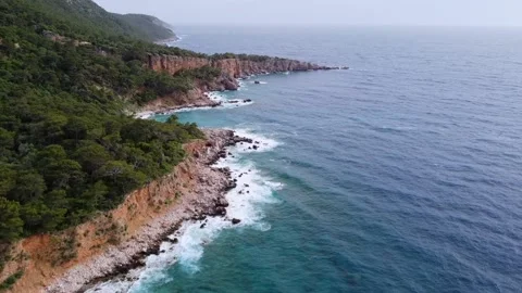 Aerial view waves breaks on rocks at sunset on tropical island. Stock Footage 166417012