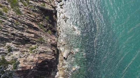 Aerial view of waves crashing against the mountain at Bluff Point near Yeppoon,  Stock Footage 195278317