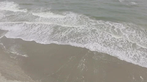 Aerial view of waves crashing onto beach Stock Footage 68814331