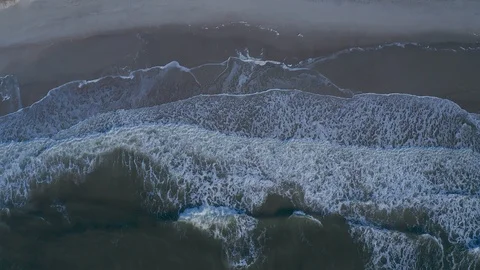 Aerial view of the waves crashing on the beach. Stock Footage 123258809