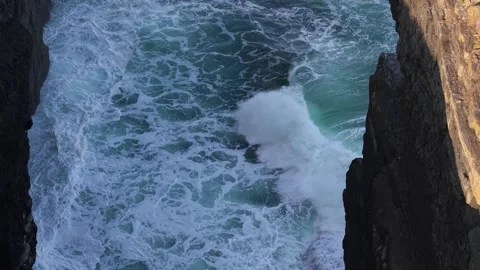 Aerial View of Waves Crashing Between Steep Cliffs at Loop Head, County Clare Stock Footage 345701020