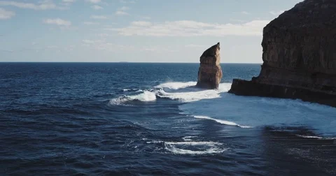 Aerial view of waves crashing on dramatic sea cliff coastline Stock Footage 77436444