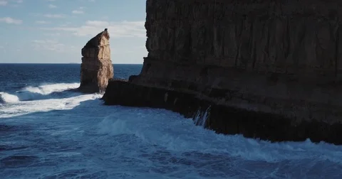 Aerial view of waves crashing on dramatic sea cliff coastline Stock Footage 77437213