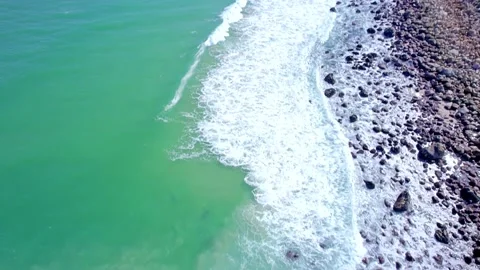 Aerial view of waves crashing on rocks at beach 動画素材 201839145