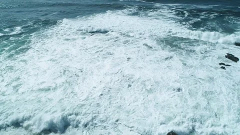 Aerial view of waves crashing on rocks The Concept of power Stock Footage 336544324