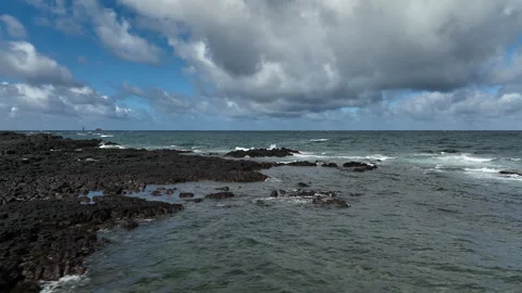 Aerial view of waves crashing on a volcanic rocky coastline, South Korea Vidéo 346716445
