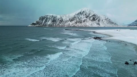Aerial view of waves drumming on the beach in Norway Stock Footage 318583816