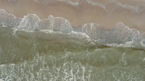 Aerial view of waves on a gritty tropical beach. Stock Footage 156050832