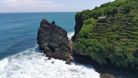 Aerial view of the waves hitting the rocks Stock Footage 239614401
