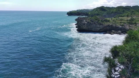Aerial view of the waves hitting the rocks Stock Footage 239615802