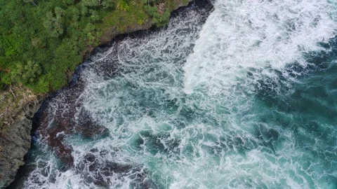 Aerial view of the waves hitting the rocks Stock Footage 239616880