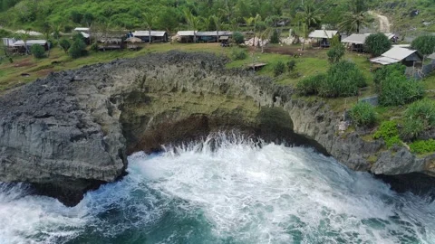 Aerial view of the waves hitting the rocks Stock Footage 239617486