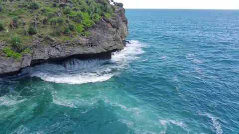Aerial view of the waves hitting the rocks Stock Footage 239617547