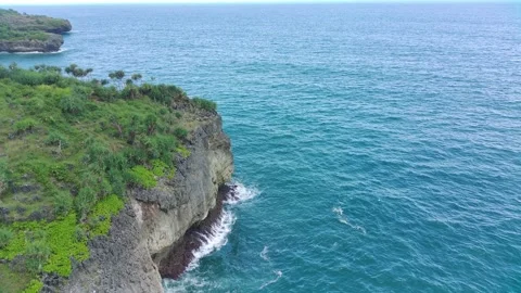 Aerial view of the waves hitting the rocks Stock Footage 239618488