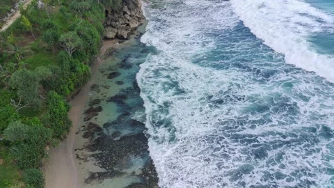Aerial view of the waves hitting the rocks Stock Footage 239620539