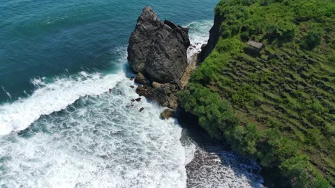 Aerial view of the waves hitting the rocks Stock Footage 239621031