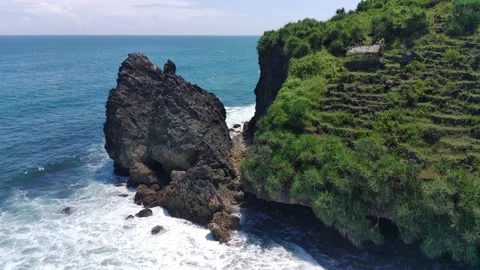 Aerial view of the waves hitting the rocks Stock Footage 239621079
