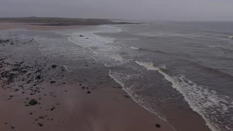 Aerial view of waves hitting sandy beach in Scotland Video stock 333148205