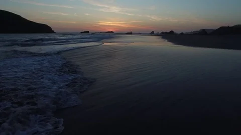 Aerial View of Waves Lapping and Birds Flying Along Shoreline at Sunset 스톡 동영상 71161311
