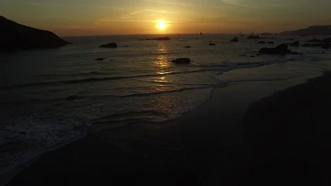 Aerial View of Waves Lapping On The Shore At Sunset Stock Footage 71158241