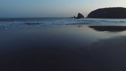 Aerial View of Waves Lapping Shore At Sunset 스톡 동영상 71162962