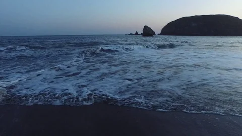 Aerial View of Waves Lapping Shore At Sunset Stock Footage 71162963