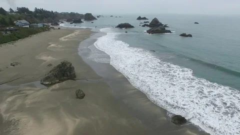 Aerial View of Waves Lapping Shore Along Coastal Town Video stock 71162994