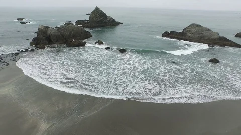 Aerial View of Waves Lapping Shore of Rocky Coast Stock Footage 71164220