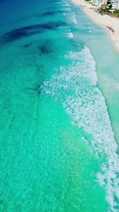 Aerial view of waves reaching the shore of a Cancun beach Stock Footage 342090312