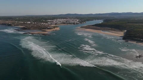 Aerial view of waves rolling into the Mira River estuary, Vila Nova de Milfontes Stock Footage 346373942