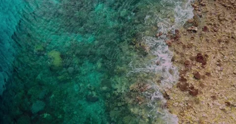 Aerial View of Waves Rolling Over Coral Reef Edge Stock Footage 329142990