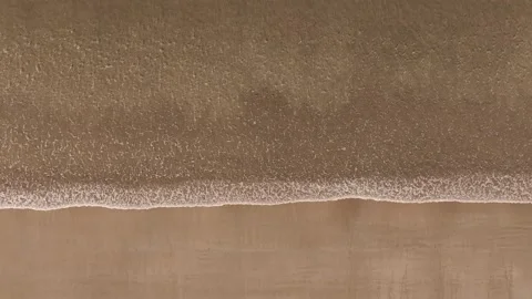 Aerial View Of Waves Rushing Over Coastline Of Beach Vídeos de archivo 295123764