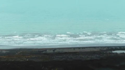 Aerial view of waves in the sea by a black volcanic beach in West Iceland 動画素材 116863636