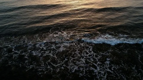 Aerial view of waves on the sea at sunset Stock Footage 102156552