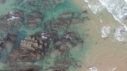 Aerial view of the waves touching a cluster of rocks, Sagres, Portugal Stock Footage 240399557