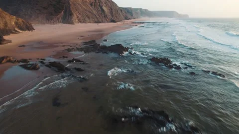 Aerial View of Waves Transitioning to Barriga Beach in Portugal at Sunset Stock Footage 229972435
