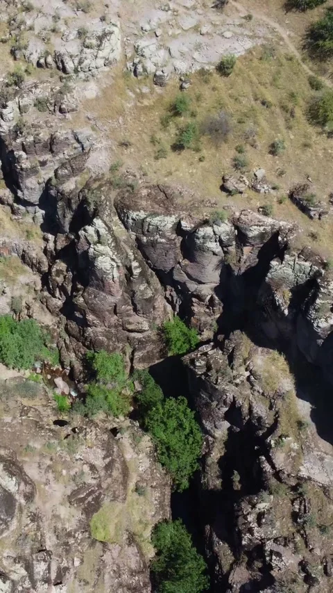 Aerial view of weathered basalt cliffs and dry gorge topography in Kazakhstan Stock Footage 338124607