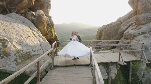 Aerial view wedding couple in mountain rock from drone in sunset landscape Stock Footage 213628722