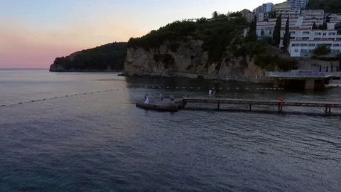 Aerial view of wedding on the pier with mountain background. Stock Footage 79983174