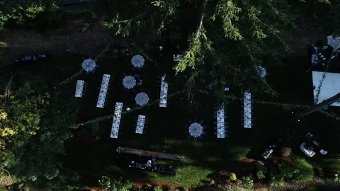 Aerial view of wedding reception in forest garden with long white tables 库存影片 104818887